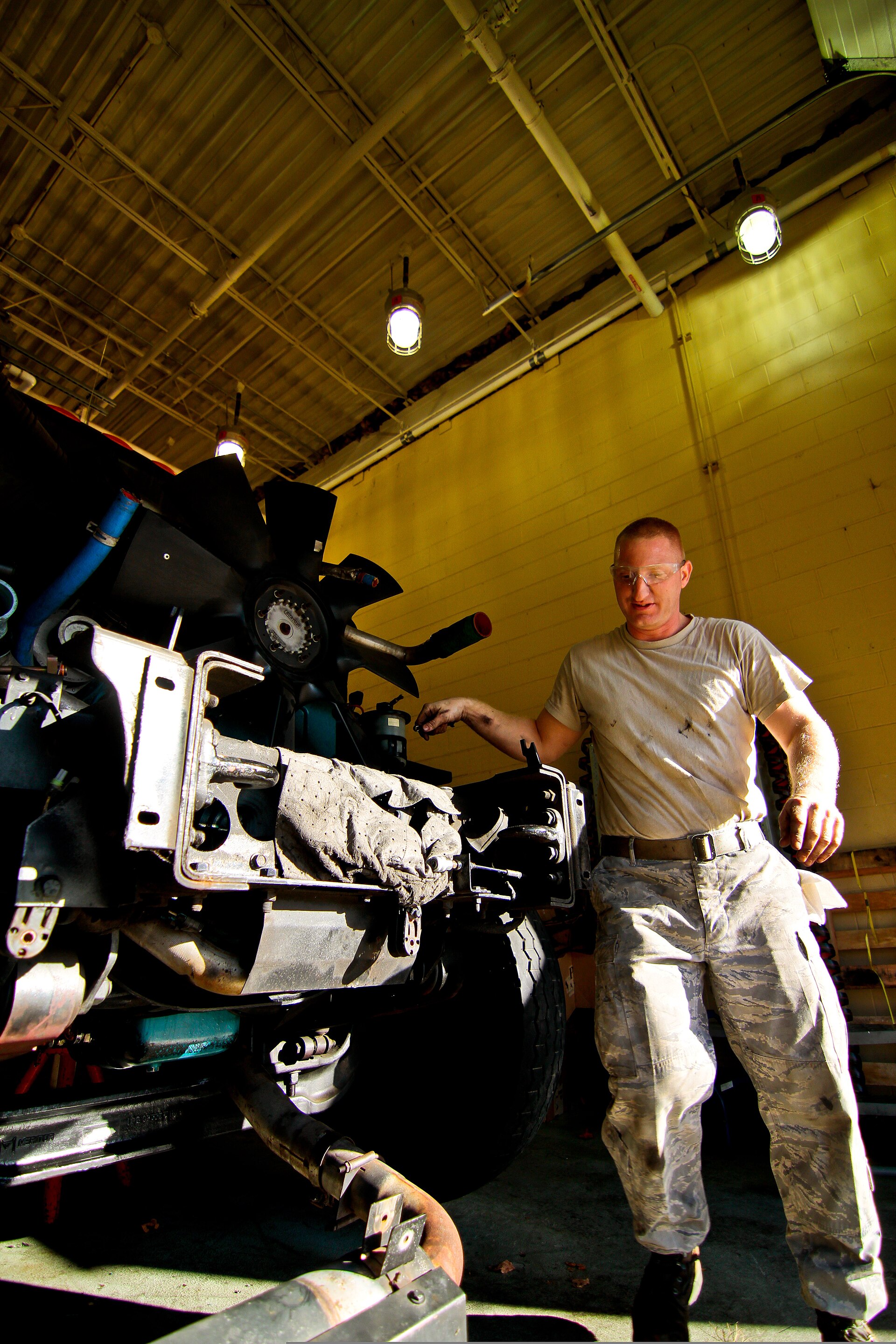 Twin Screw technician servicing a diesel engine on-site
